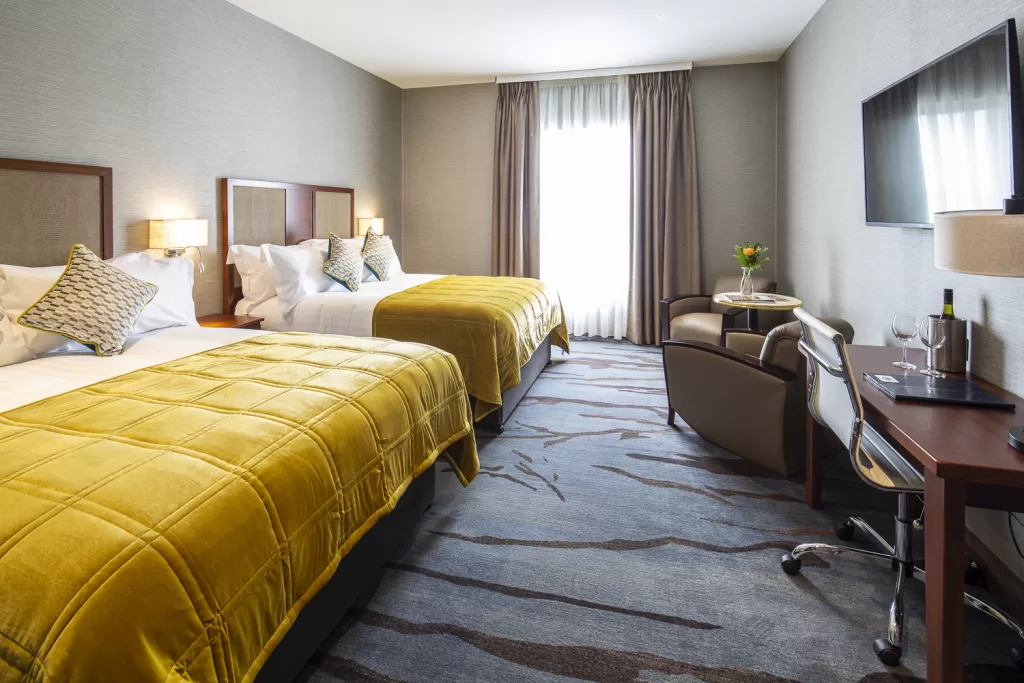 One of the bedrooms at Lawlor's of Naas, with two big bed with yellow covers.