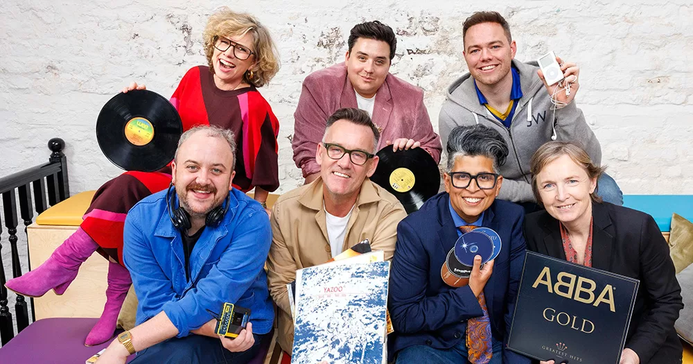 Promotional photo for new LGBT Ireland campaign, Empowering Anthems. The photo shows seven people posing close together in two rows, holding CDs and vinyls.