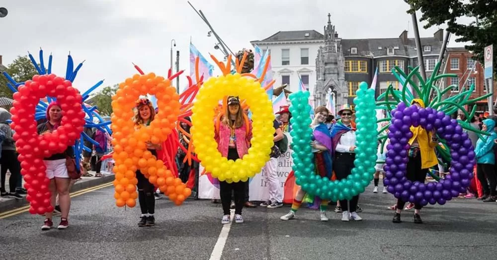People caring large rainbow coloured balloons spelling out the word Pride to represent the first Pride event in Athlone.