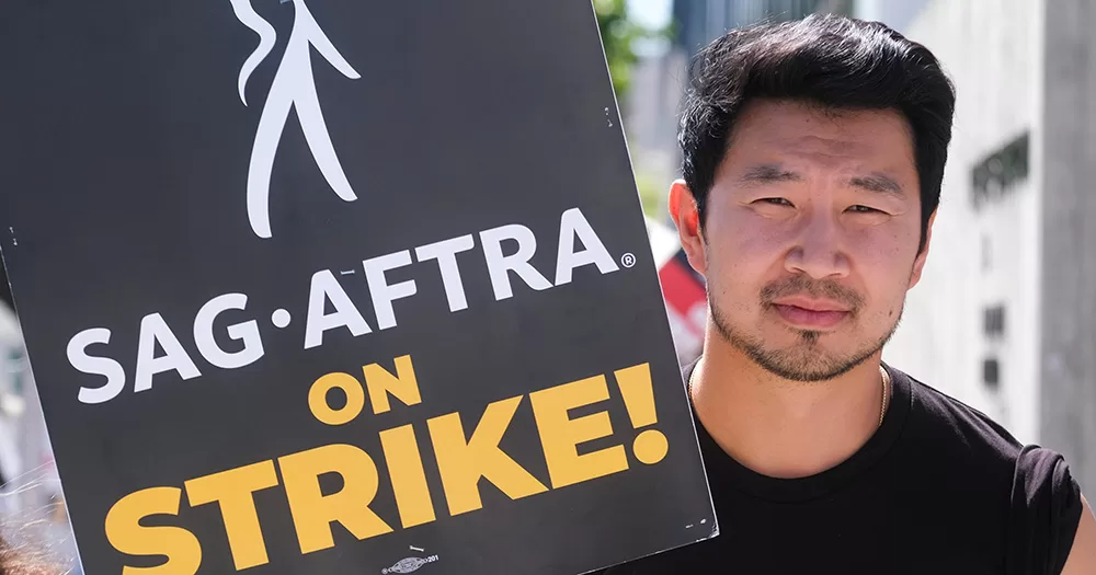 Actor Simu Liu joins the SAG-AFTRA strike walking with a picket outside Culver Studios in Culver City, California.