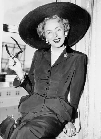 Christine Jorgenson poses with a hat and sunglasses and she is remembered alongside other prominent LGBTQ+ women in history