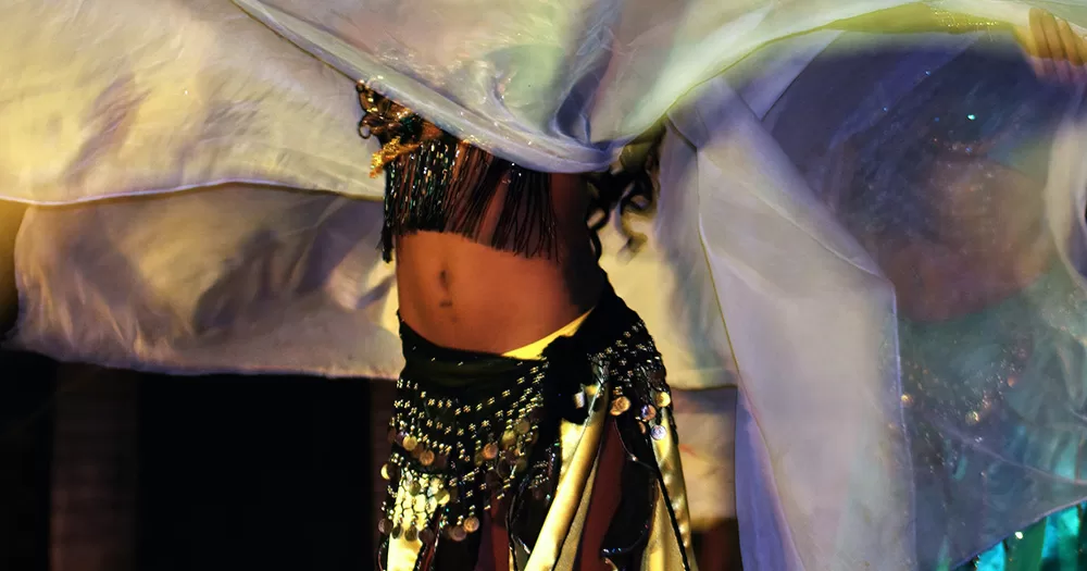 The abdomen of a person belly dancing.