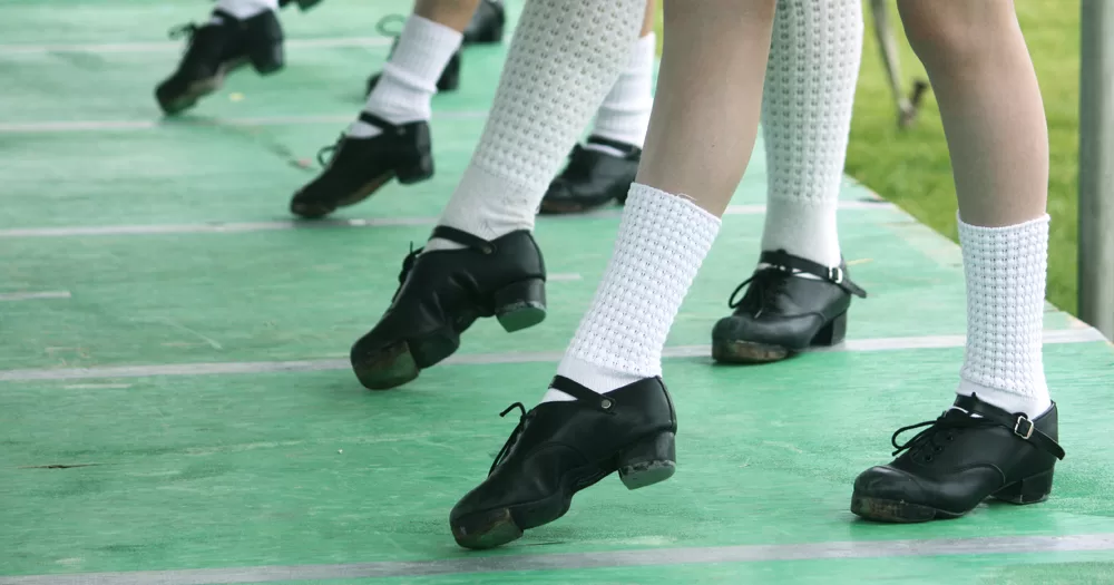 This article is about trans women in Irish dancing. In the photo, legs of people performing Irish dancing, with the traditional shoes on.