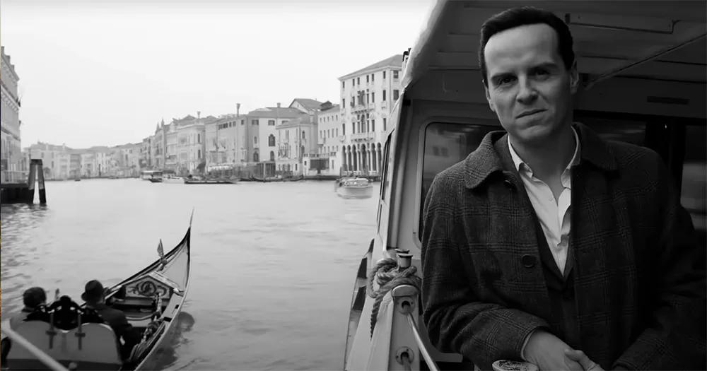 Black and white screenshot of Andrew Scott in the trailer for Netflix's Ripley. Scott is placed on the right hand side of the screen, photographed on a boat from the stomach up.