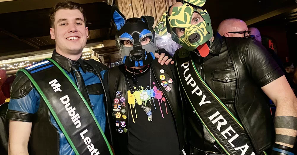 Mr Dublin Leather and Puppy Ireland 2024 posing for a picture with another man, all in leather gear with puppy masks.