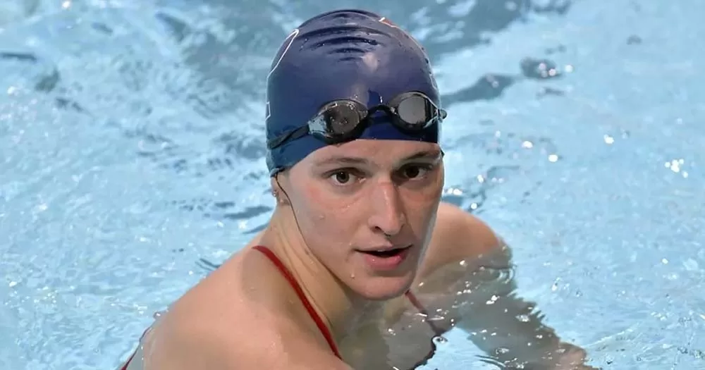 Swimmer wearing swim cap and goggles in pool, competitive swimmer Lia Thomas is fighting World Aquatics transphobic ban.