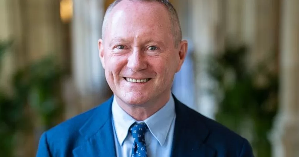 Michael O'Flaherty, who was elected as the new Council of Europe’s Commissioner for Human Rights, smiling at the camera, wearing a blue suit, with a blurry background.