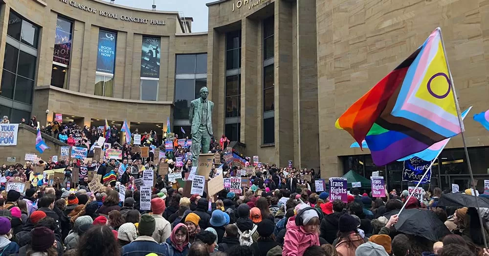 Photo of large crowd of people gathering in Scotland carrying Pride flags supporting the proposed conversion therapy ban