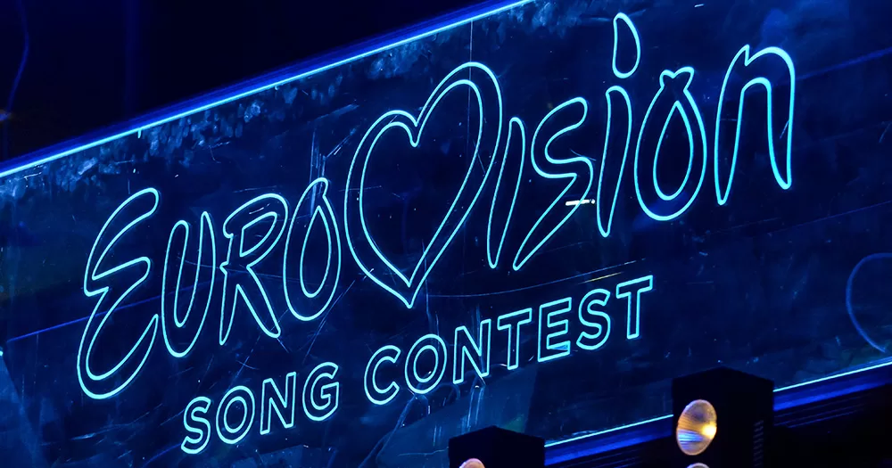 This image shows the Eurovision Song Contest logo, a competition which Israel is taking part in. The logo is displayed on a screen, in white lights on a dark blue background.