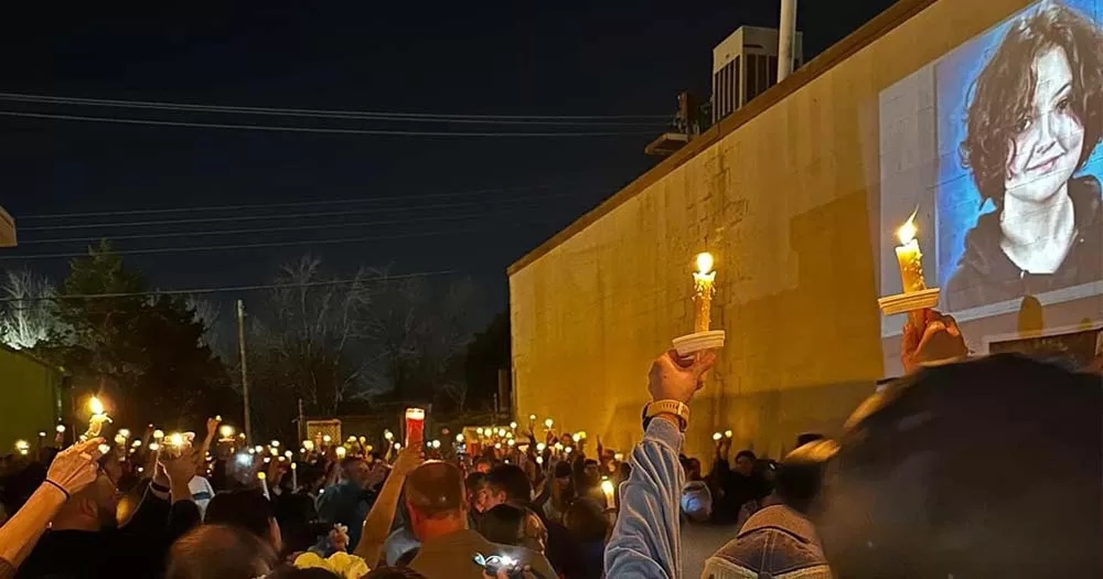 Photograph of people holding candles at a vigil for Nex Benedict.