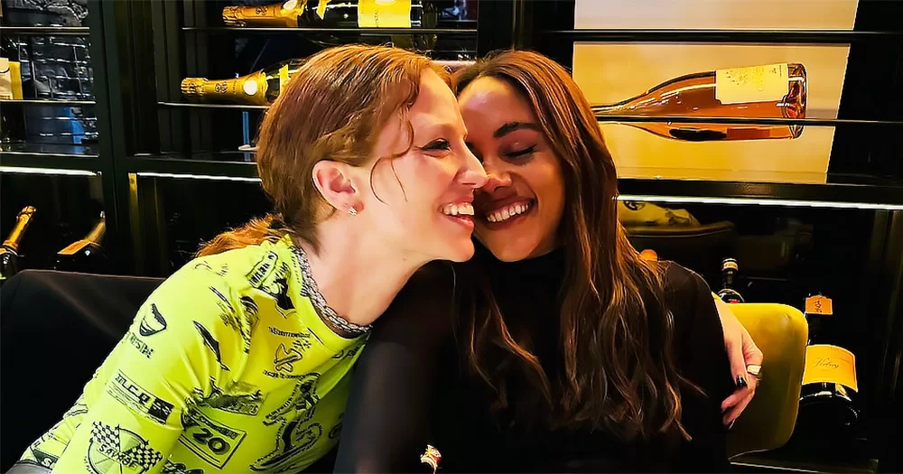 The picture shows Jess Glynne, on the left, and Alex Scott, on the right, both smiling, now officially in a relationship.