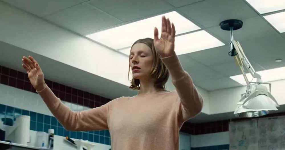 Screen grab of Hunter Schafer her raising hands over her head from the trailer of the new Kinds of Kindness film
