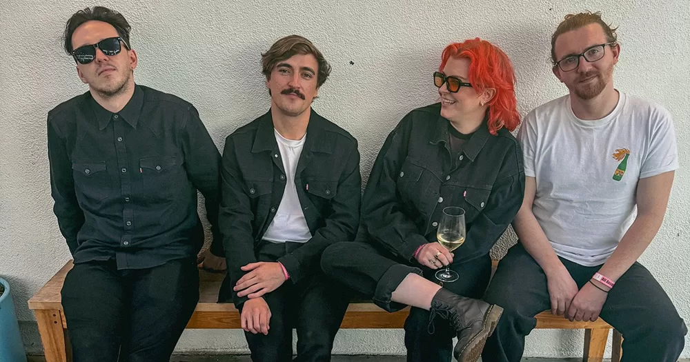 An image of Sprints, one of the Irish acts to pull out of SXSW festival. The four-piece group are pictures sitting on a bench.