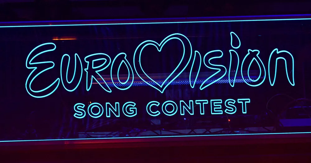 This article is about the lyrics of Israel's Eurovision entry. The image shows a neon "Eurovision Song Contest" sign.