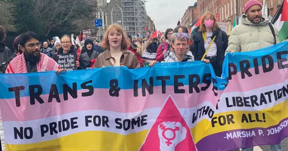 Photo of people carrying Trans Pride banner, representing recent trans healthcare statement in Ireland.