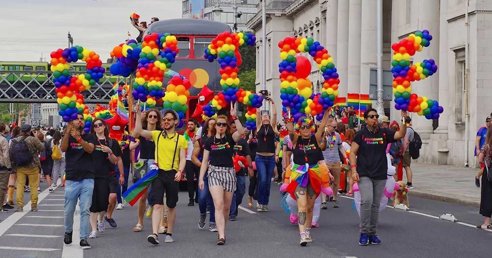 Participants of the Dublin LGBTQ Pride Festival hold colorful letters that form the word PRIDE.