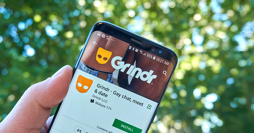 Cover Photo of Grindr on a phone screen for lawsuit after allegedly sharing user's HIV status without consent.