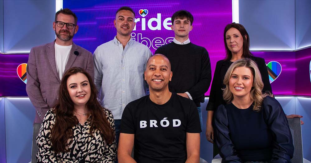 Photo of seven people sitting in front of Pride Vibes purple background.