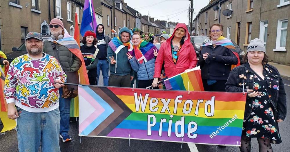 Photo of people carrying the Wexford Pride parade banner