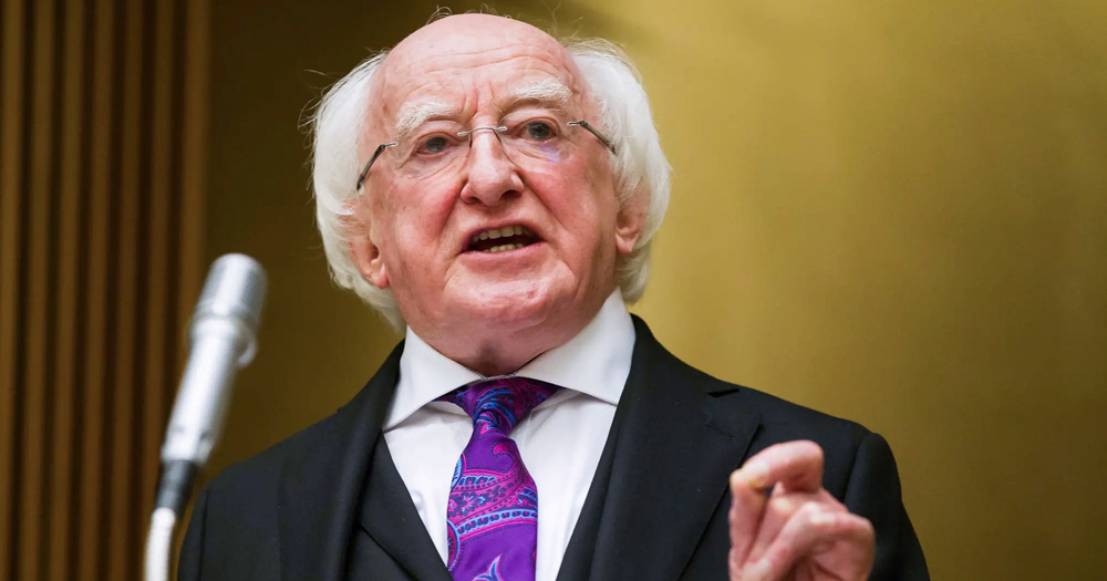 President Michael D Higgins, who recently spoke about libraries targeted by far-right groups, speaking at an event with a microphone in front of him.