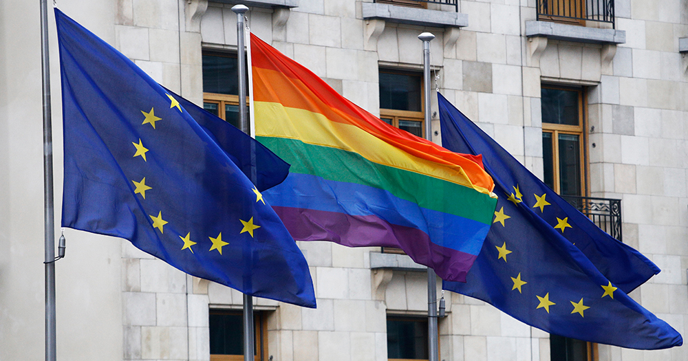This article is about candidates in the European elections who support LGBTQ+ rights. In the photo, two EU flags and a Pride flag waving.