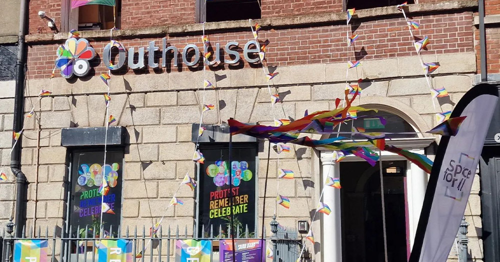 A photo of Dublin's Outhouse LGBTQ+ Centre decorated with Pride flags.