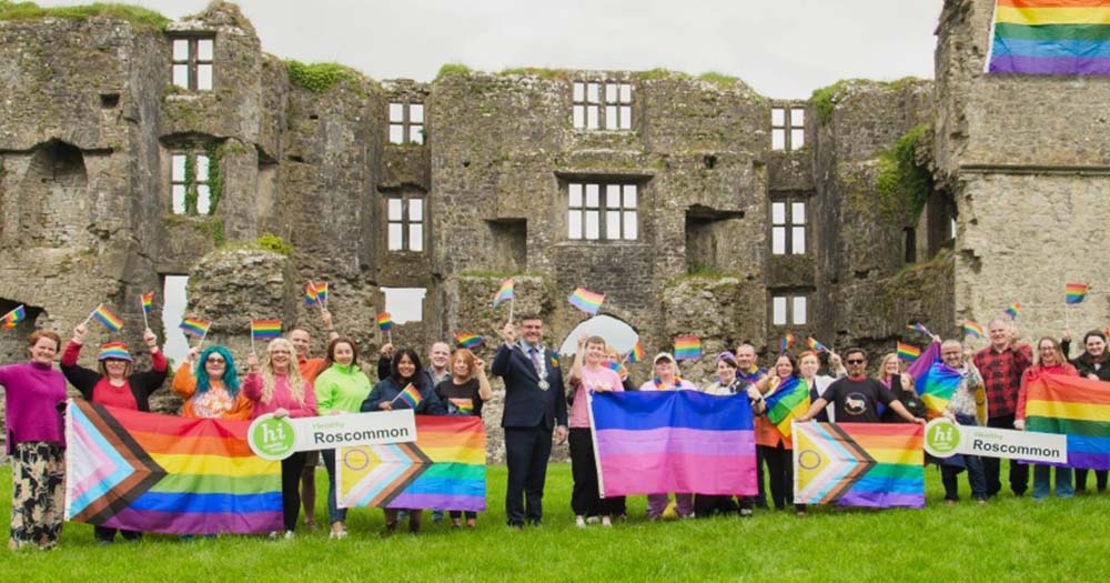 Photo of group of volunteers posing with Pride flags in Roscommon