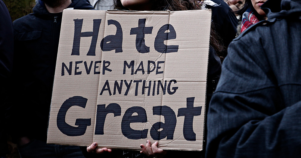 This aritcle is about Ireland's hate offences bill. The image shows a cardboard sign that reads "Hate Never Made Anything Great".