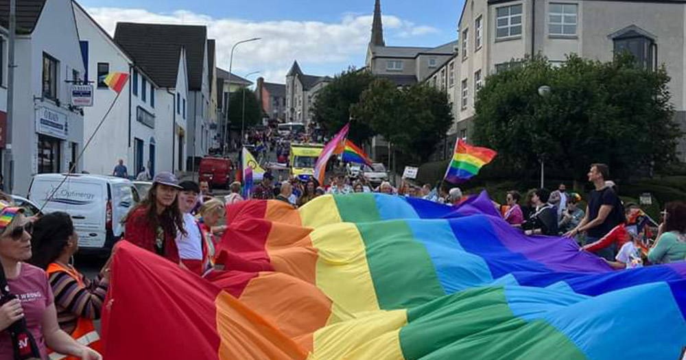 Photo of a giant rainbow flag being hauled through the streets of Letterkenny, Co Donegal during the 2023 Letterkenny Pride festival.