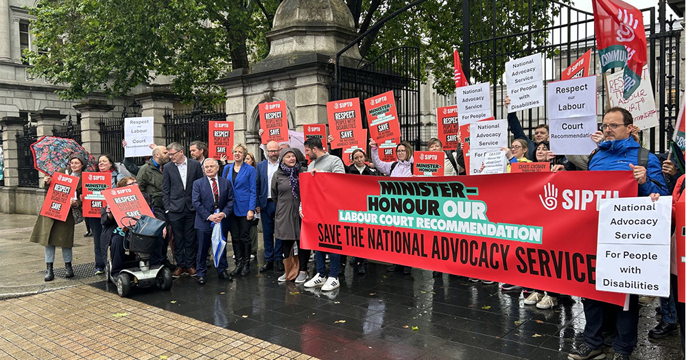 NAS workers and SIPTU union members holds a banner which reads, "Minister-houour our Labour Court recommendation save the National Advocacy Service" outside the Dáil.