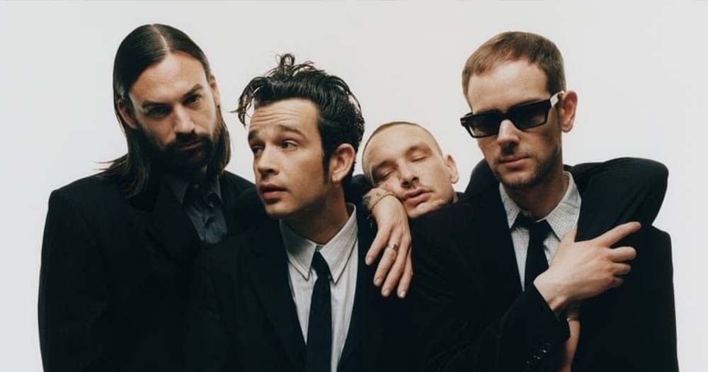 Photo of the 1975 band posing in suits, the band has been sued following last year's on-stage kiss