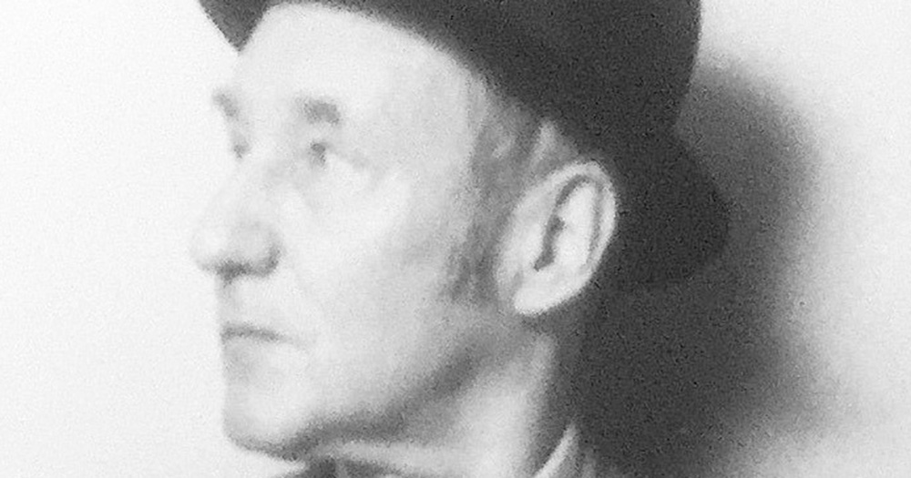 A black and white photo of William S. Burroughs, the author of the Queer novel.