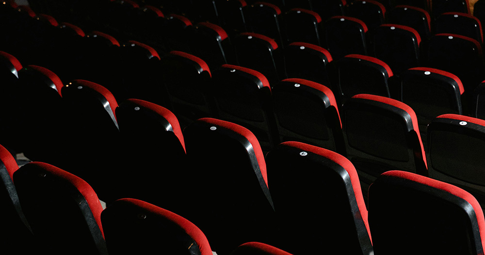 London is about to get its first LGBTQ+ cinema. The image shows rows of black and red cinema seats.