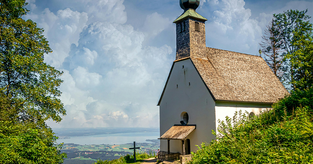 In this text the author writes about the influence of being a protestant pastor's daughter on her coming out as a lesbian. The picture shows a small church in Southern Germany on a mountain, overlooking lake Chiemsee.