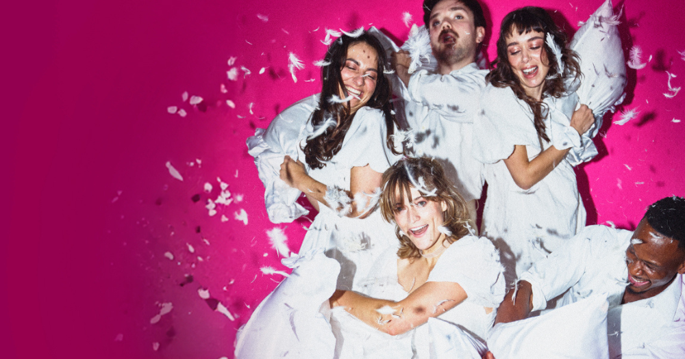 A promotional image for Emma, due to make its European premiere in Dublin. It shows cast members having a pillow fight in white clothes, with white feathers flying around.