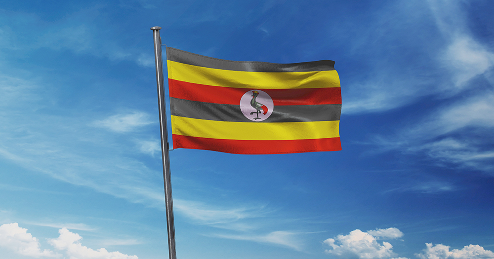 This article is about a court ruling in favour of Ugandan men who were tortured. Photo of the Ugandan flag (with black, yellow and red stripes) flying on a blue sky.