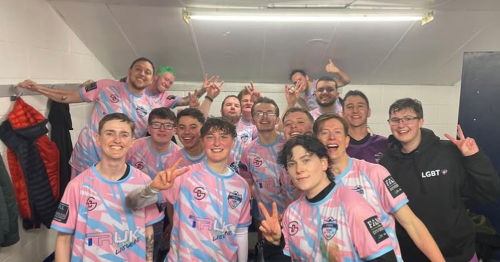 TRUK United FC grouped together in their uniform in their changing room.