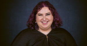 Portrait of queer Irish teenager Lea Hennessy smiling.