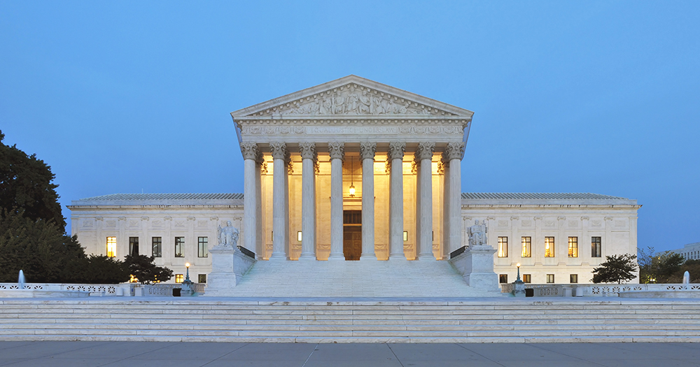 Photo of the US Supreme Court, which rejected Trump's bid to freeze foreign aid. The photo is taken from the front of the court, which is illuminated from the inside.