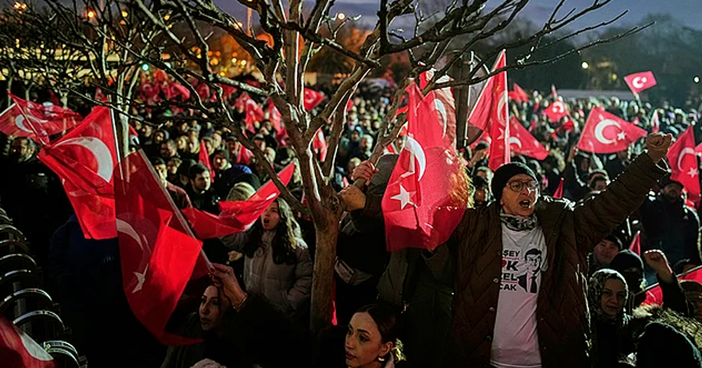 Photo of one of the protests that have erupted in several Turkish cities, with people waving Turkish flags and marching.