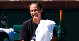 Daria Kasatkina sitting down smiling with a towel over her shoulder.