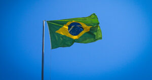 This article is about a Brazilian court allowing gender-neutral ID. In the photo, a Brazilian flag flying on a blue sky.