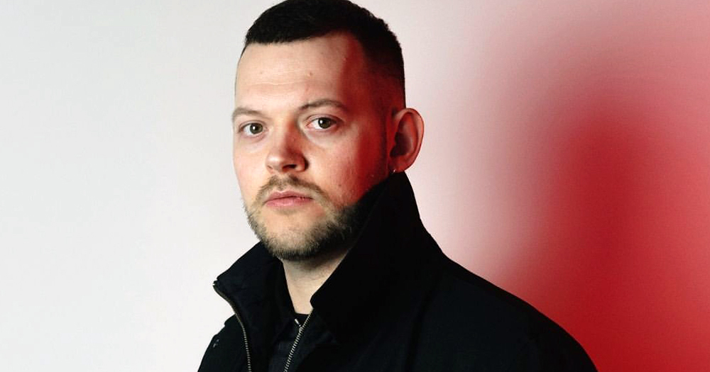 Irish fashion designer Colin Horgan, who recently announced his brand's closure, looking at the camera while wearing a black sweatshirt.
