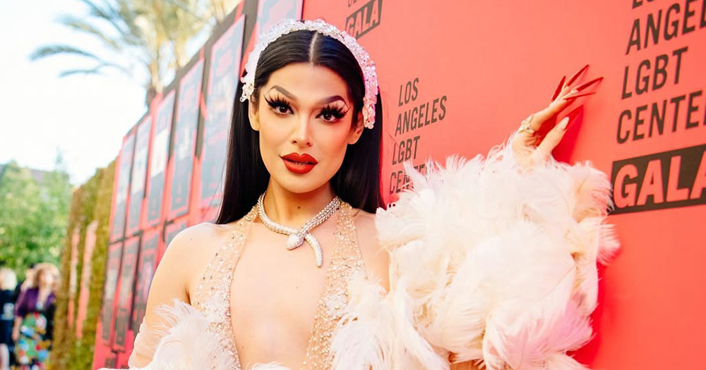 Drag Race star Valentina, who recently came out as trans, posing for a photo in an elegant white dress.