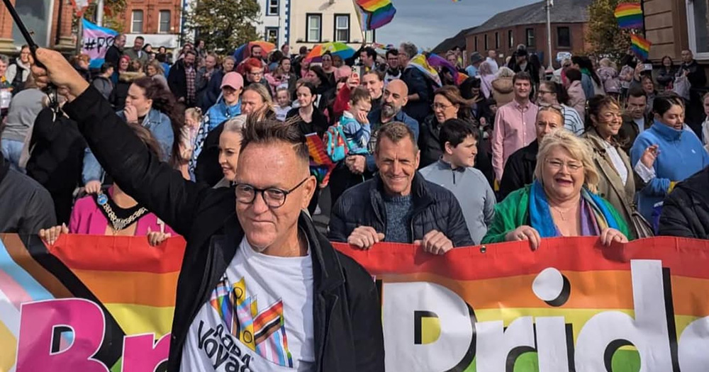 An image from Lurgan Pride 2024, showing a large crowd of people walking through the streets.