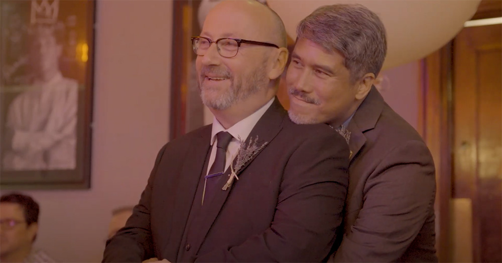 Richard standing with his arms around Conor in the Prom Night short film.