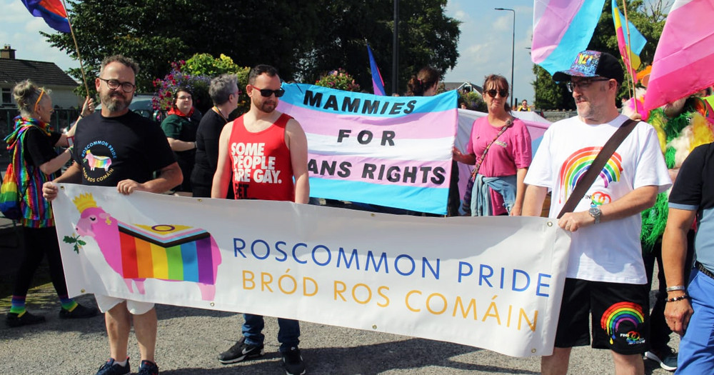 Photo of Roscommon Pride, returning in 2025, with participants holding banners and flags.