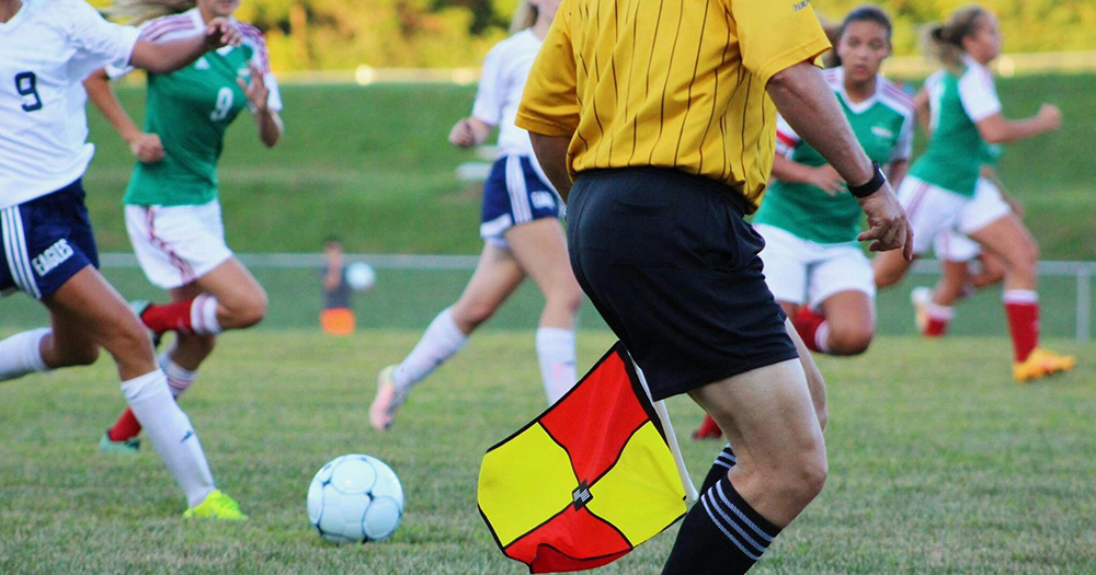 A photo of two women's teams playing a football match.