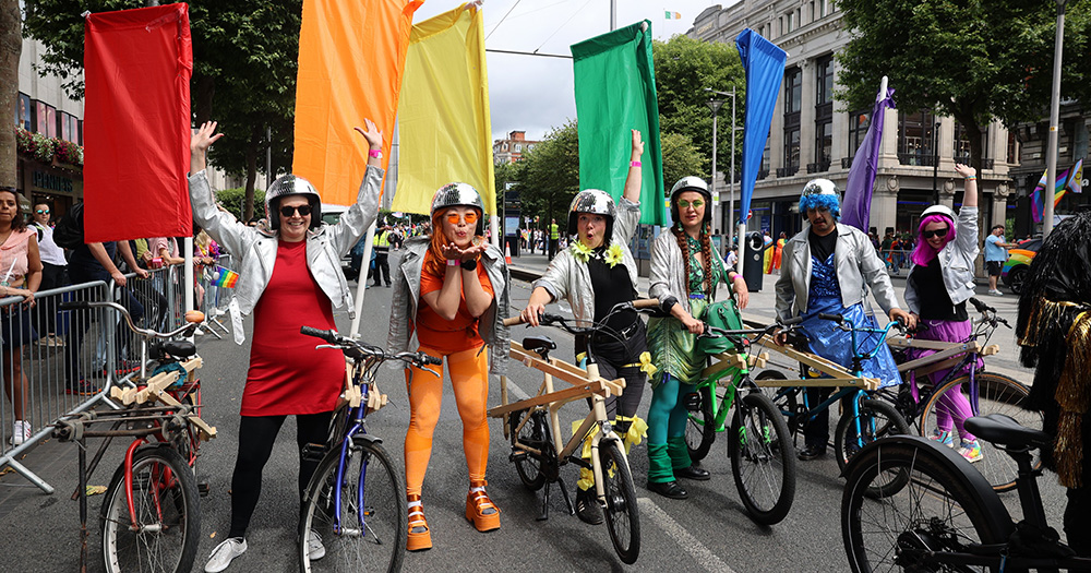 An image of cyclists with different coloured flags at the 2025 Dublin Pride parade.