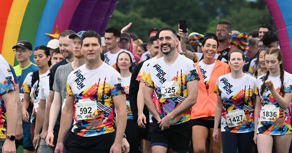 Participants in the Dublin Pride Run in Phoenix Park walking through the finish line.